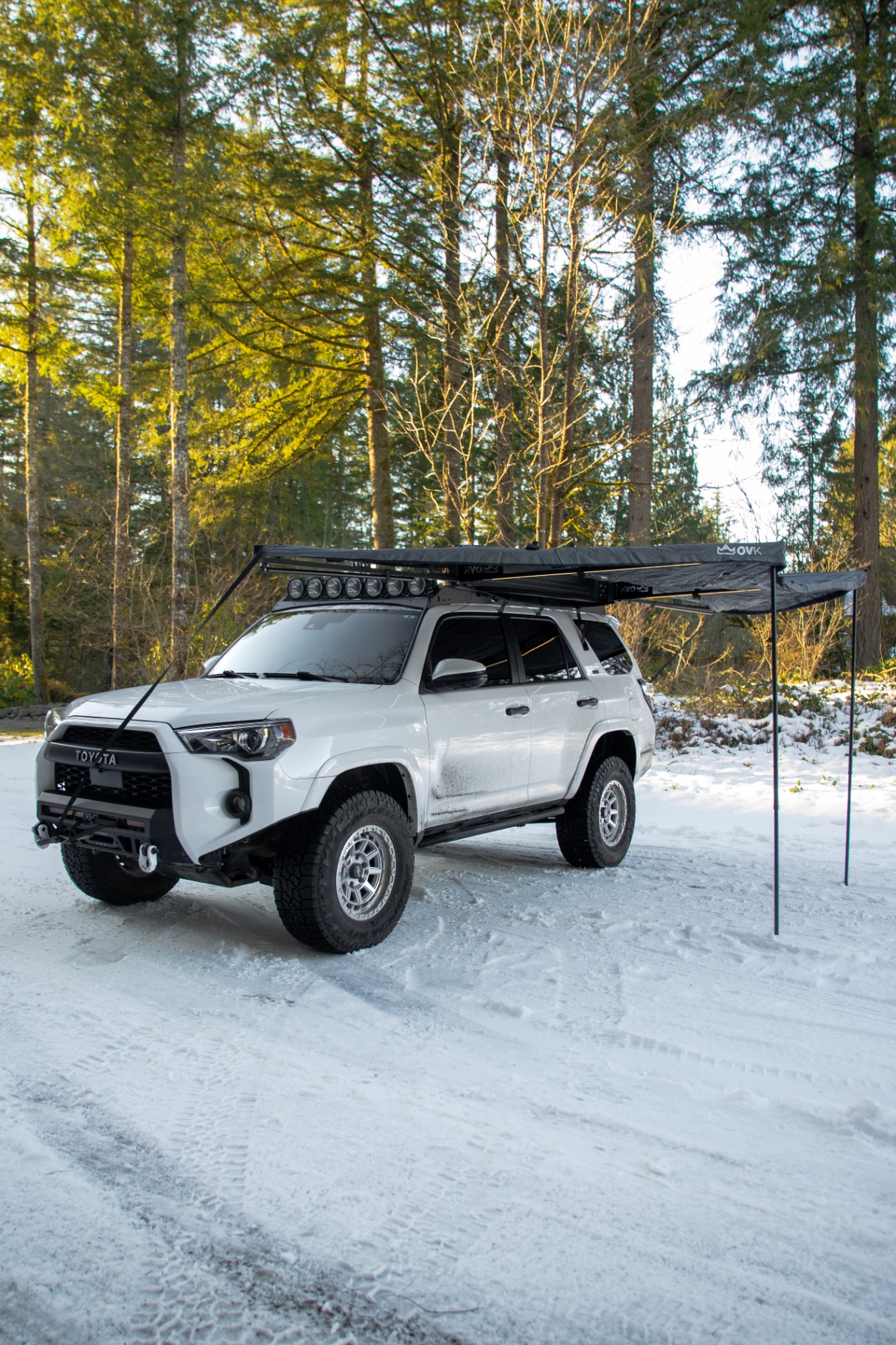 4Runner with rooftop awning parked in snowy forest