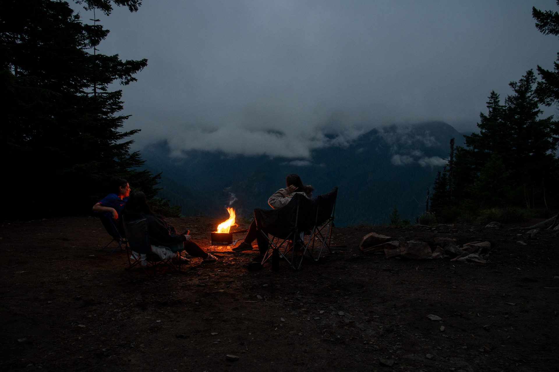 Marie Dubray with friends around a campfire at a mountain overlook